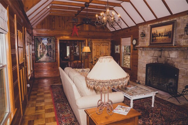 living room with dark parquet flooring, a stone fireplace, lofted ceiling with beams, and wood walls