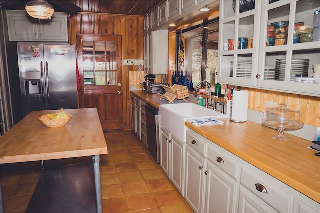 kitchen with white cabinets, stainless steel refrigerator with ice dispenser, and butcher block counters