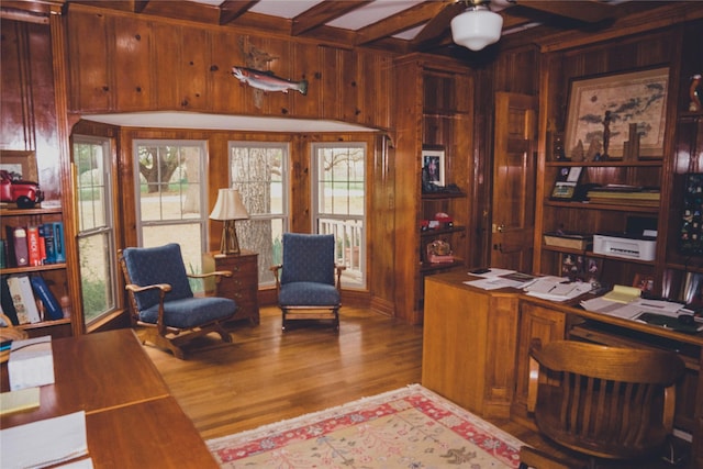 office area featuring ceiling fan, wooden walls, light wood-type flooring, and a healthy amount of sunlight