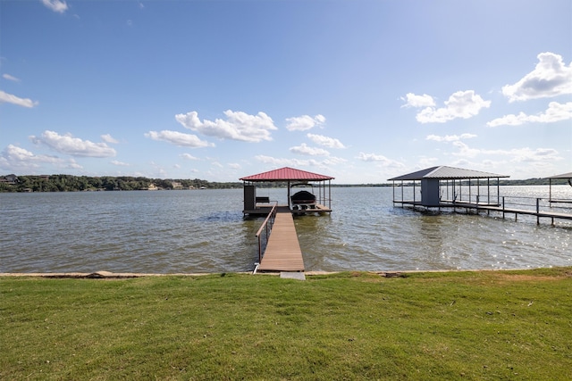 dock area featuring a water view and a lawn