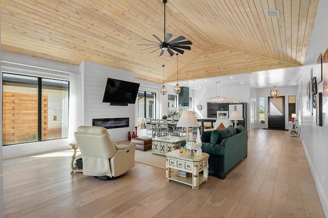 living room with wood ceiling, ceiling fan, high vaulted ceiling, a fireplace, and light hardwood / wood-style floors