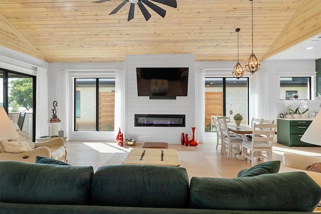 living room with lofted ceiling, a fireplace, light hardwood / wood-style floors, and wooden ceiling