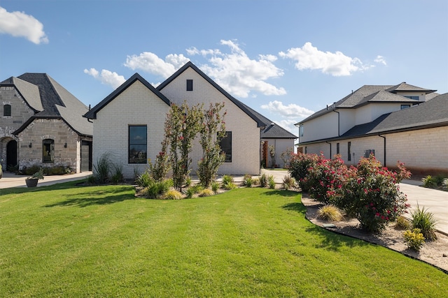 french provincial home featuring a front yard