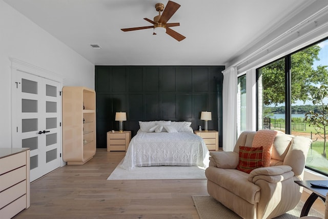 bedroom with ceiling fan and light hardwood / wood-style flooring