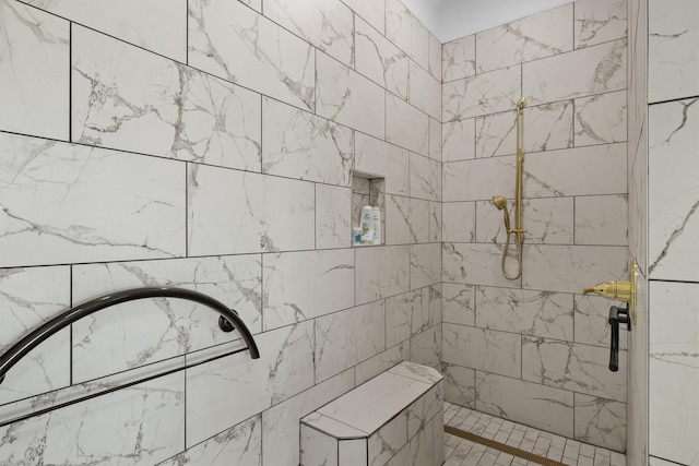 bathroom with a tile shower