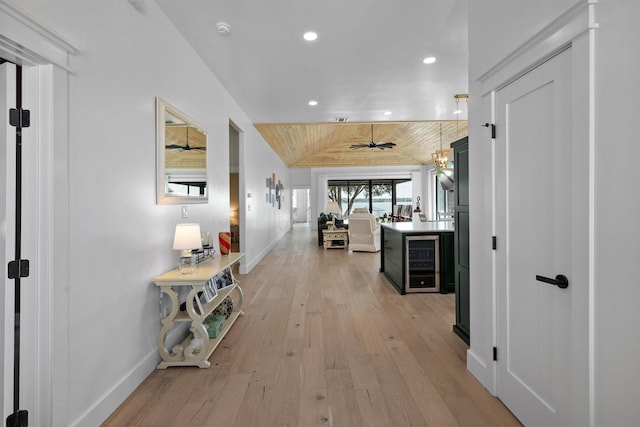 hallway with vaulted ceiling, wooden ceiling, beverage cooler, and light wood-type flooring