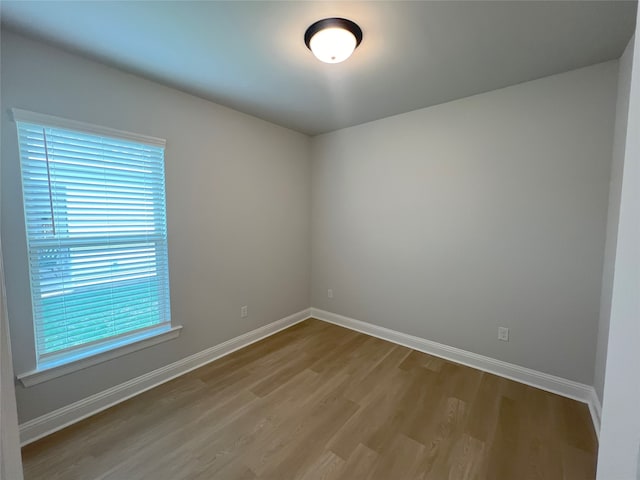 spare room with hardwood / wood-style floors