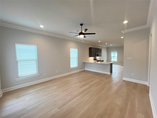 unfurnished living room featuring crown molding, light wood finished floors, baseboards, recessed lighting, and a ceiling fan