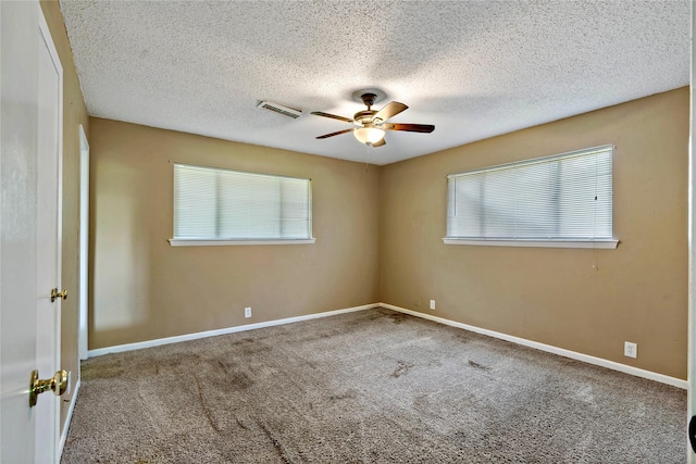 carpeted empty room with a textured ceiling and ceiling fan