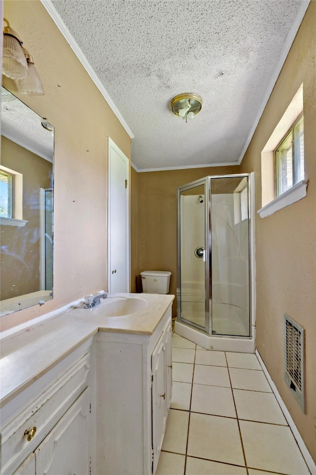 bathroom with vanity, tile patterned floors, toilet, a textured ceiling, and an enclosed shower