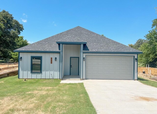 view of front of property with a garage and a front yard