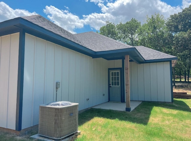 exterior space with central AC and a lawn