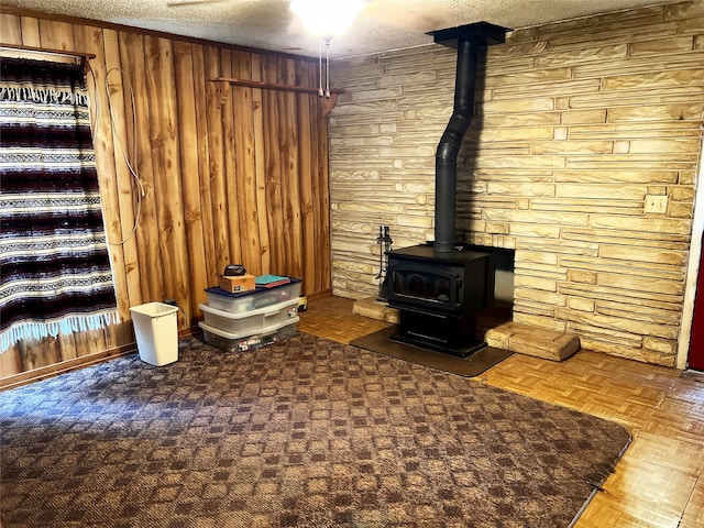 unfurnished living room with wooden walls, parquet floors, and a textured ceiling