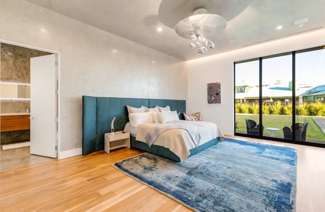 bedroom with access to exterior and wood-type flooring