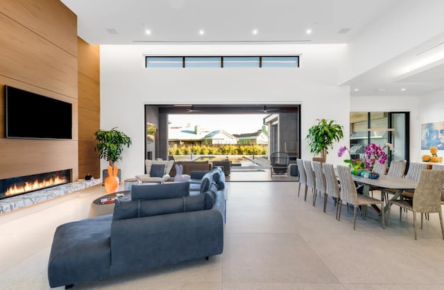 living room featuring a large fireplace and a high ceiling