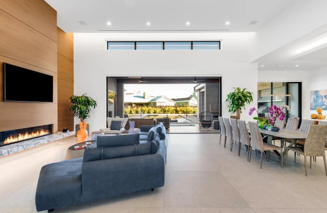 living room featuring a towering ceiling and a fireplace