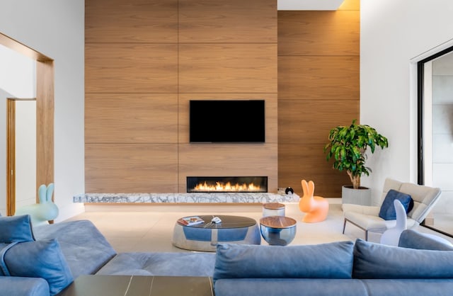 living room with a large fireplace and wooden walls