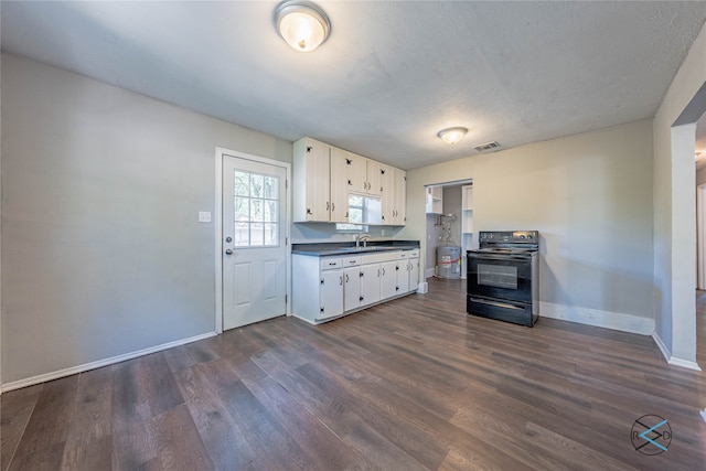 kitchen with black electric range oven, sink, white cabinetry, and dark hardwood / wood-style floors