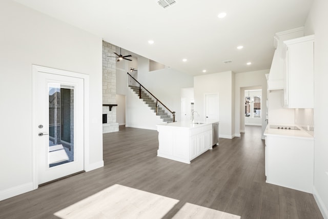 kitchen featuring white cabinetry, dark hardwood / wood-style floors, and a fireplace