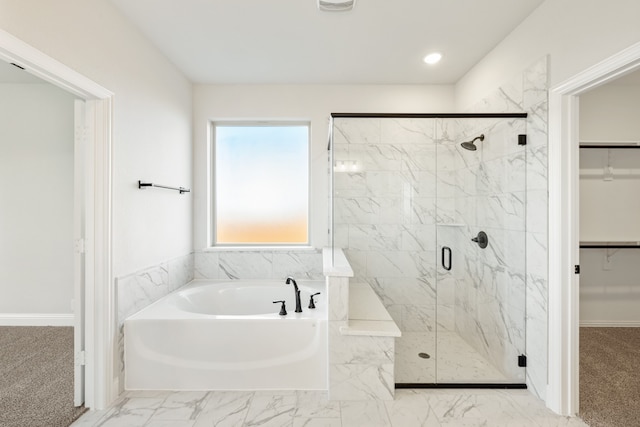 bathroom featuring shower with separate bathtub