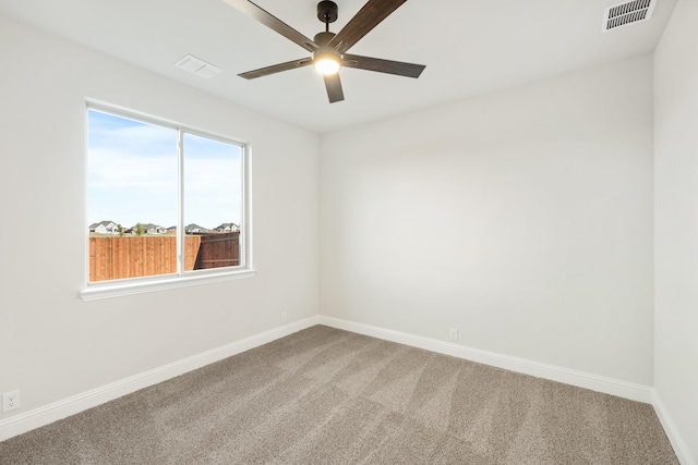 carpeted spare room with ceiling fan