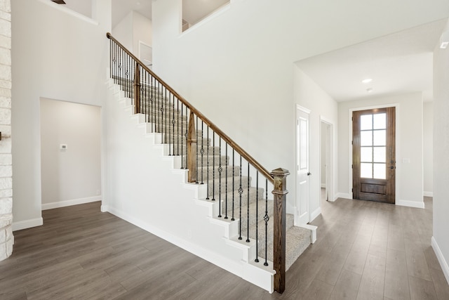 entryway featuring hardwood / wood-style flooring and a high ceiling