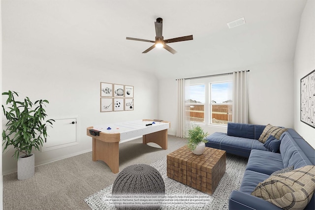 interior space featuring ceiling fan, light colored carpet, and vaulted ceiling