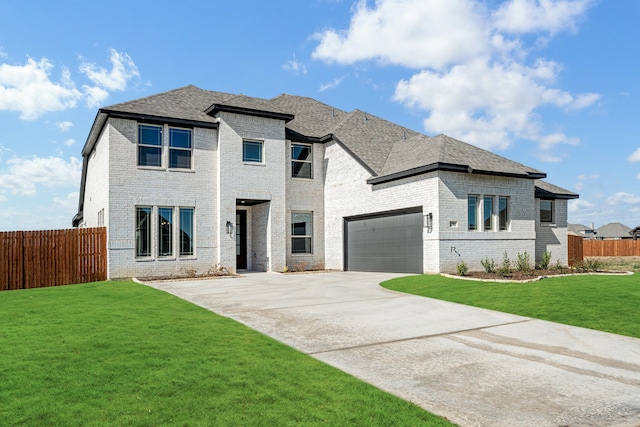 view of front of home featuring a front lawn and a garage