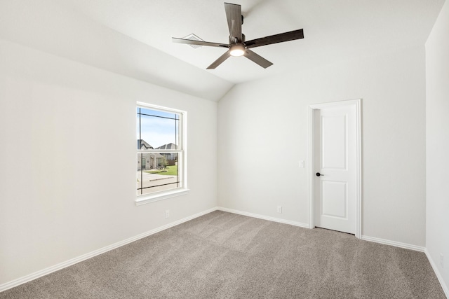 carpeted empty room featuring vaulted ceiling and ceiling fan