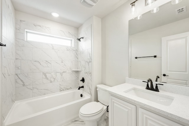 full bathroom with tiled shower / bath, vanity, and toilet