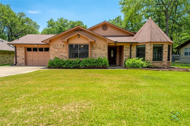 view of front facade with a front yard and a garage