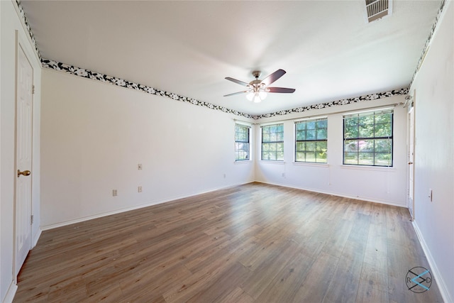 empty room featuring hardwood / wood-style flooring and ceiling fan