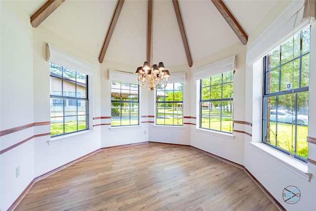 unfurnished sunroom with an inviting chandelier and lofted ceiling with beams