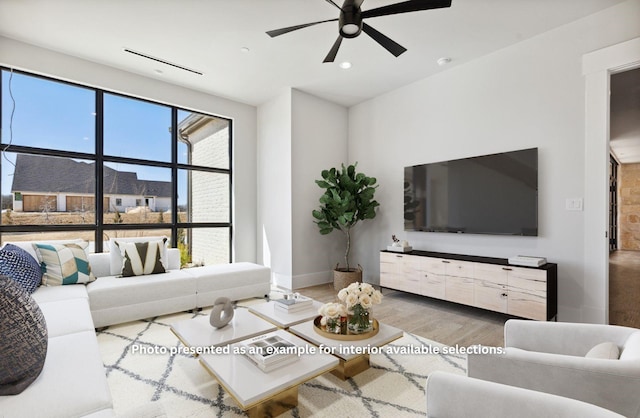 living room with ceiling fan and hardwood / wood-style floors