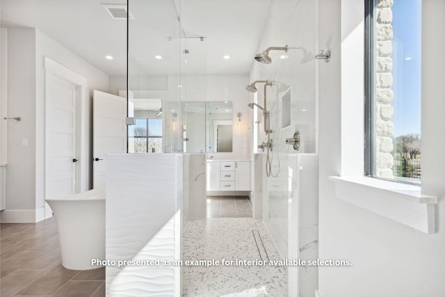 bathroom featuring vanity, a healthy amount of sunlight, and separate shower and tub