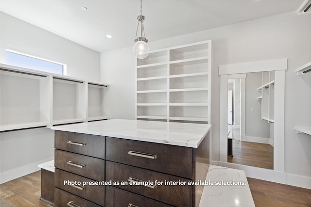 walk in closet featuring dark hardwood / wood-style flooring