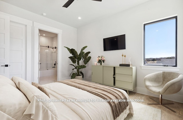 bedroom featuring ceiling fan, light hardwood / wood-style floors, and ensuite bath