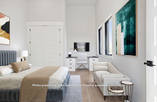 bedroom with wood-type flooring, a closet, and radiator