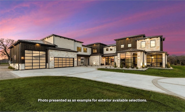 view of front of property with a garage and a yard