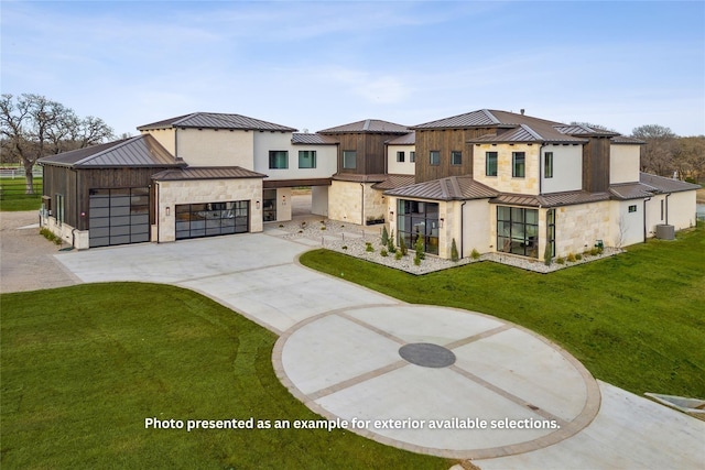 exterior space with central AC, a front yard, and a garage