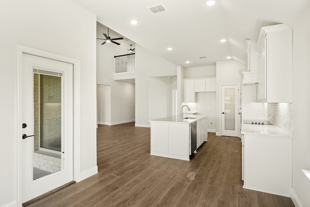 kitchen featuring white cabinetry, a kitchen island with sink, high vaulted ceiling, and dark hardwood / wood-style floors