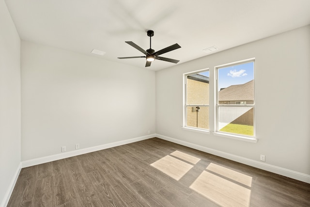 spare room with ceiling fan and hardwood / wood-style floors