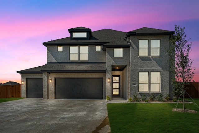 view of front of property featuring a yard and a garage