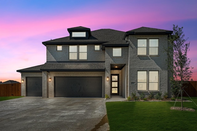 view of front facade with fence, a garage, driveway, and a front yard