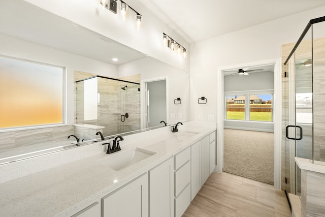 bathroom featuring vanity, independent shower and bath, ceiling fan, and plenty of natural light