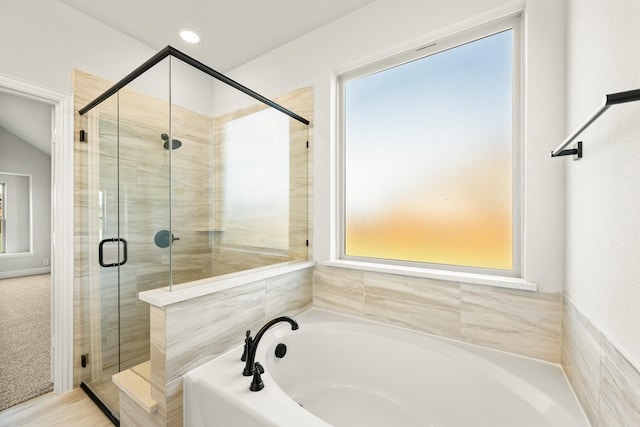 bathroom with a bath and a stall shower