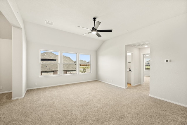 carpeted spare room featuring ceiling fan and lofted ceiling