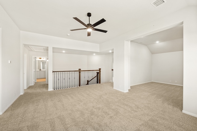 carpeted spare room with ceiling fan and lofted ceiling