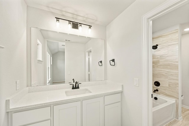 full bath featuring  shower combination, visible vents, wood finished floors, and vanity