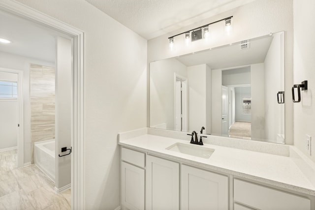 bathroom with vanity and a textured ceiling